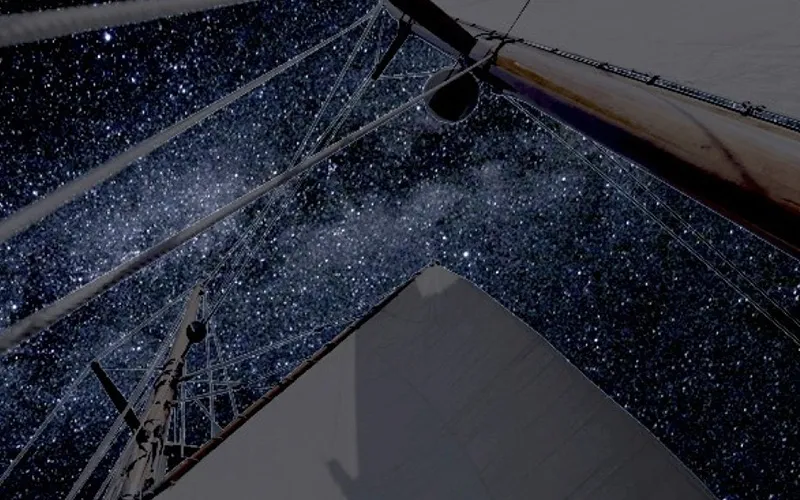 Looking up at schooner Rigging with the nighttime sky filled with stars