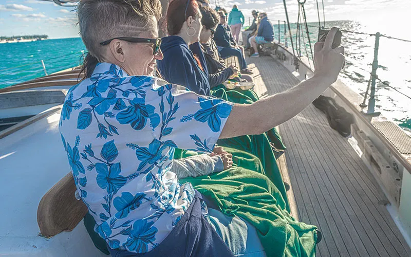 KeyWest_Champagne-Sunset_Slider-8 group of people enjoying a sunny day aboard the schooner america 2.0