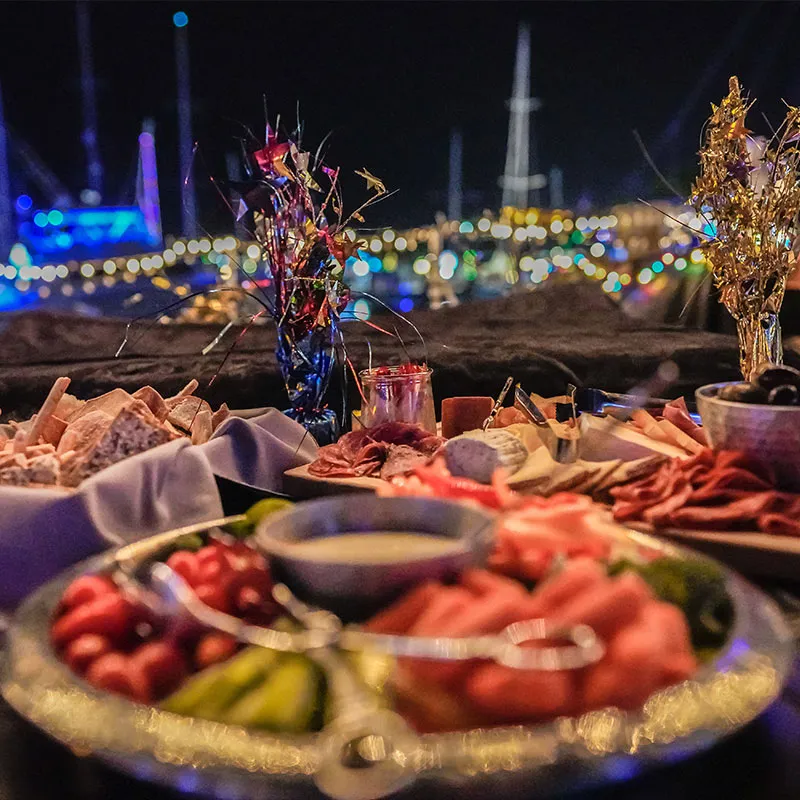 a closeup of several trays of food on a new years decorated table