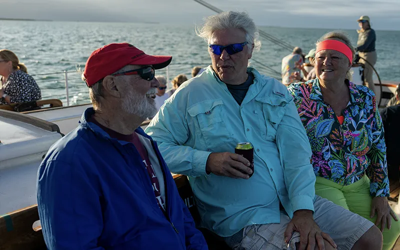 Sunset6 Three customers enjoying drinks on a sunset sail aboard Schooner America 2.0 in Key West